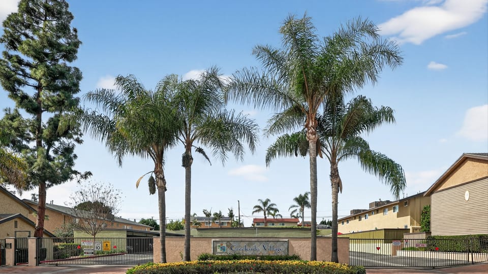 Lambert Road condo community entrance in La Habra with palm trees