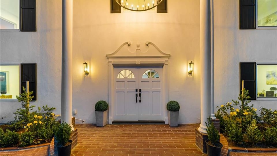 North Hills La Habra home entry with columns and warm lighting